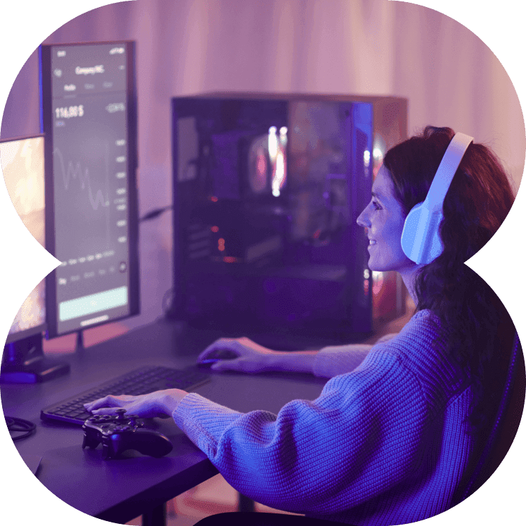 Gamer wearing headphones playing on a desktop PC